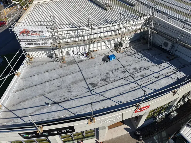 Roofer fixing concrete tiles and mortar joints